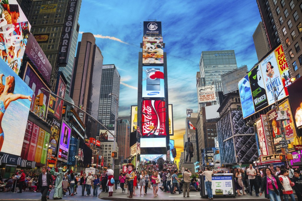 NEW YORK CITY - MAY 11: Times Square with tourists on May 11, 2013. Iconified as "The Crossroads of the World" it's the brightly illuminated hub of the Broadway Theater District.